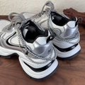 Detailed view of silver fashion sneakers with dual-layer metal chains and pearl charms - Silver Gray