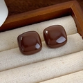 Macro shot of polished brown enamel stud earrings displayed in a vintage wooden jewelry box - Square Round Glossy Stud Earrings (26166B)