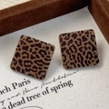 Close-up of square leopard print stud earrings with flocking texture on vintage canvas - Square (26297E)