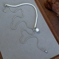 Detail of adjustable pearl necklace with silver snake chain on grey velvet display - Silver Asymmetric Pearl Splicing Style (26164B)