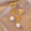 Vintage gold lace hollow heart drop earrings with white pearls on silk background - Heart Pearl Long Style (Main Image)