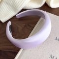 Detail of lavender satin padded headband showing handmade label on soft fabric - Light Purple