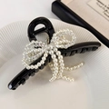 Detail of elegant black hair claw clip featuring pearl and crystal bow design - Black (25153B)