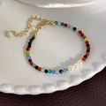 Detail of colorful faceted bead bracelet with pearls and golden clasp on white ceramic - Multicolor (25227D)