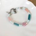 Detail of beaded bracelet with light blue beads, pink flower, and silver lobster clasp - Pink Flower And Light Blue Beaded Style (23373)
