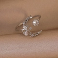 Detailed view of silver crescent moon and zircon flower ring on champagne silk - Silver Star Moon Flower Style (25294B)