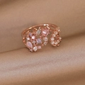Detailed close-up of rose gold flower ring with crystals and pearls on silk fabric - Rose Gold Double Layer Colored Zirconia Style (25296A)