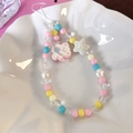 Detail of beaded phone strap with resin bear charm and colorful acrylic stars - 25374A Pink Bear