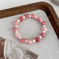 Close-up of pink stone beaded bracelet on textured fabric with wooden tray background - Pink Large Beads (B)