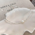 Detail of silver box chain necklace with white pearl in a shell jewelry tray - Milk White Pearl