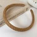 Detailed macro view showing the brown straw woven texture and inner lining of the headband - Brown