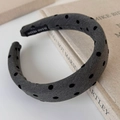 Detail eines grauen gepolsterten Haarreifs mit Punkten auf einem Buch mit Handmade-Label - Grau mit schwarzem Punktmuster / 3CM Breit