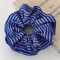 Macro shot of striped blue and white fabric scrunchie with soft pleated texture details - Dark Blue Striped