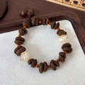 Detailed view of coffee bean beads and cat paw charms on a creative beaded bracelet - White Cat Claw Style (24135B)
