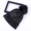 Chic black ribbed knit beanie featuring a fluffy pom-pom for winter warmth and style - Adult / Black