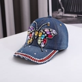 Denim baseball cap with colorful butterfly rhinestones and distressed brim details - One Size / Blue