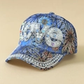 Close-up of sparkling rhinestone LOVE letters and pearl embellishments on floral cap - One Size / Blue