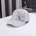 Close-up of a grey baseball cap with colorful butterfly sequins and crystal rhinestones - Gray