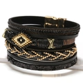 Pulsera multicapa bohemia de cuero con cuenta de ojo y detalles metálicos dorados - Negro