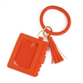 Close-up of bright orange lychee pattern leather card holder with wristlet and tassel detail - Orange