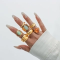 Golden alloy ring set with green and orange acrylic stones in diverse stackable designs - Gold Ring Set Three