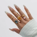 Set of 7 gold alloy rings featuring orange and grey acrylic stones and hammered textures - Gold Ring Set Six