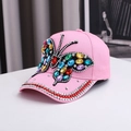 Pink baseball cap featuring a large colorful rhinestone butterfly and crystal brim accents - One Size / Pink