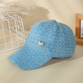 Close-up of light blue tweed baseball cap featuring gold threads and heart pearl charm - Light Blue
