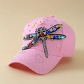 Detail of pink cotton baseball cap featuring multi-colored rhinestone dragonfly and daisies - Pink