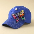 Detailed close-up of a blue baseball cap featuring a large colorful rhinestone butterfly - Blue