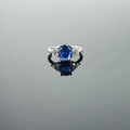 Elegant silver ring with an oval blue gemstone and small side diamonds on a gray mirror - US 5 / Blue Stone