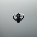 Elegant silver ring featuring a large oval black gemstone and side diamond accents - US 5 / Black Stone