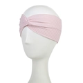 Close-up of light pink ribbed knit headband featuring a stylish center twist detail - Light Pink