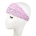 Detailed view of pink paisley pattern headband on model showing soft elastic fabric texture - Light Pink