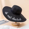 Black wide brim straw sun hat with white Do Not Disturb embroidery and black ribbon bow - One Size / Black