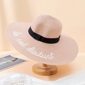 Detail of pink straw sun hat with black ribbon and do not disturb embroidery - One Size / Shrimp Pink