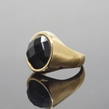 Polished gold signet ring featuring a large faceted oval black gemstone on mirror surface - US 7 / Gold Base Black Faceted Stone