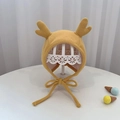 Detailed macro of yellow knitted baby bonnet with cute soft 3D deer antlers and chin ties - 40-48cm / Yellow