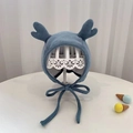 Detail of blue knit baby hat featuring cute reindeer antlers and cotton chin ties - 40-48cm / Blue