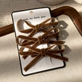 Three-piece brown velvet ribbon bow hair clips on white card, macro detail on fabric - Bowknot Hair Clip (24346D) / Brown