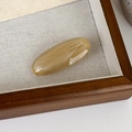 Detailed macro view of an oval amber marble hair clip with France Handmade engraving - Grey Coffee Multicolor