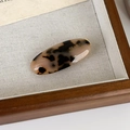 Detail of tortoise shell acetate oval hair clip featuring FRANCE Handmade gold lettering - Light Tortoiseshell