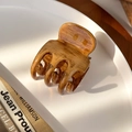 Detailed view of vintage wood-texture hair claw clip on white ceramic tray - Triple Tooth Claw Clip