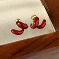 Detailed shot of retro deep red glaze heart geometric earrings with golden metallic finish - 3D Spiral Style (11# 24322A)