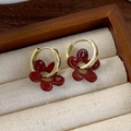 Macro detail of vintage dark red floral earrings with golden hoops on a linen display - Vintage Flower Style (19# 26192A)