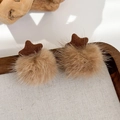 Dettaglio di orecchini a stella in peluche con maglia marrone e dettagli in ecopelliccia beige - Accessorio Capelli Stella in Maglia (24252C)