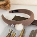Detail of brown knitted headband with white faux pearl and soft fur pompom accent - Light Coffee