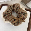 Detail of a plaid scrunchie with white lace trim and a brown bow in a vintage style - Olive Green Hounds-tooth