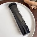 Macro view of high elasticity black hair ties neatly stored in a clear cylindrical container - Solid Black