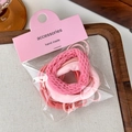 Detailed view of pink gradient bow hair ties set in elegant retail packaging - Pink Series